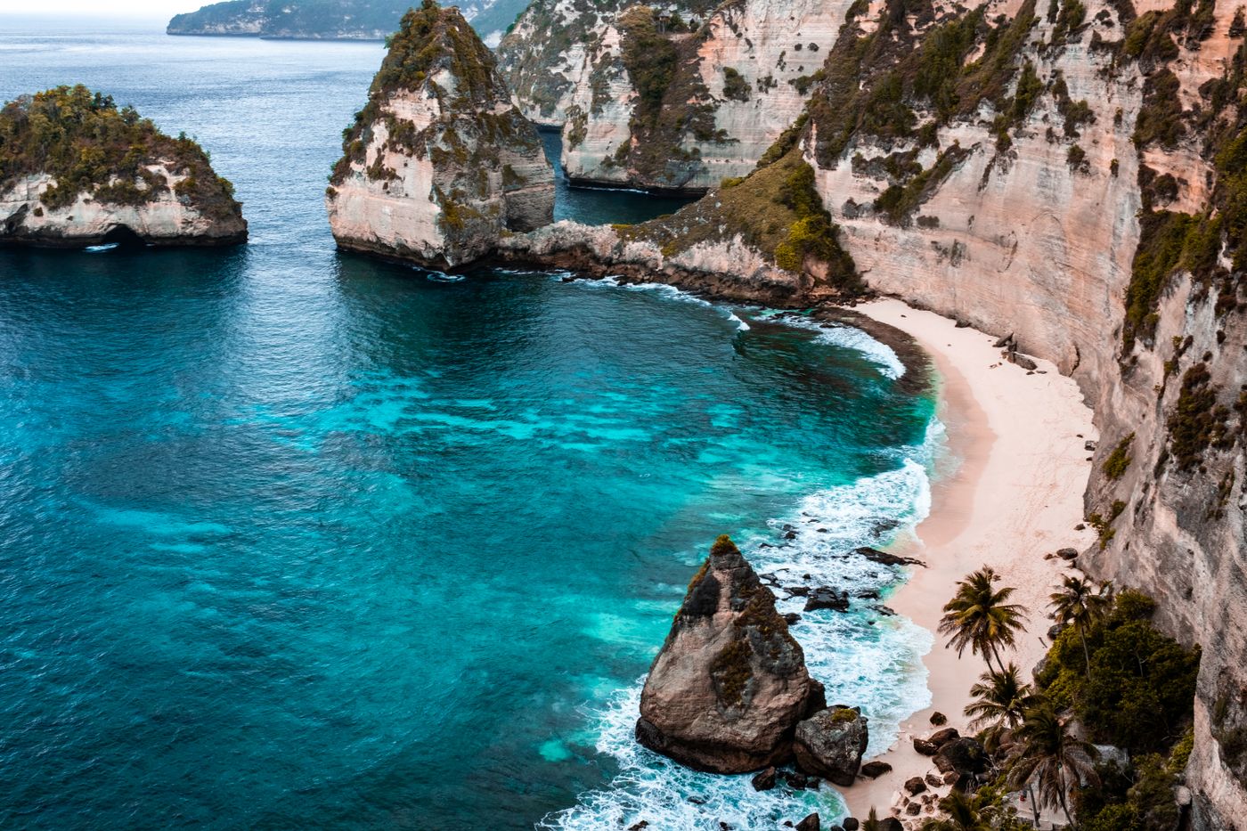 Clear blue water beside a rocky coastline